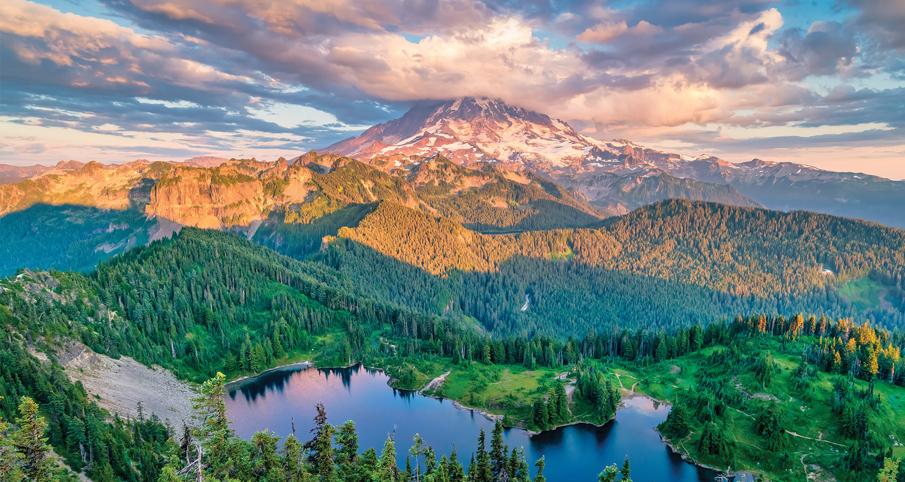 Mountain landscape with a lake and forest at sunset